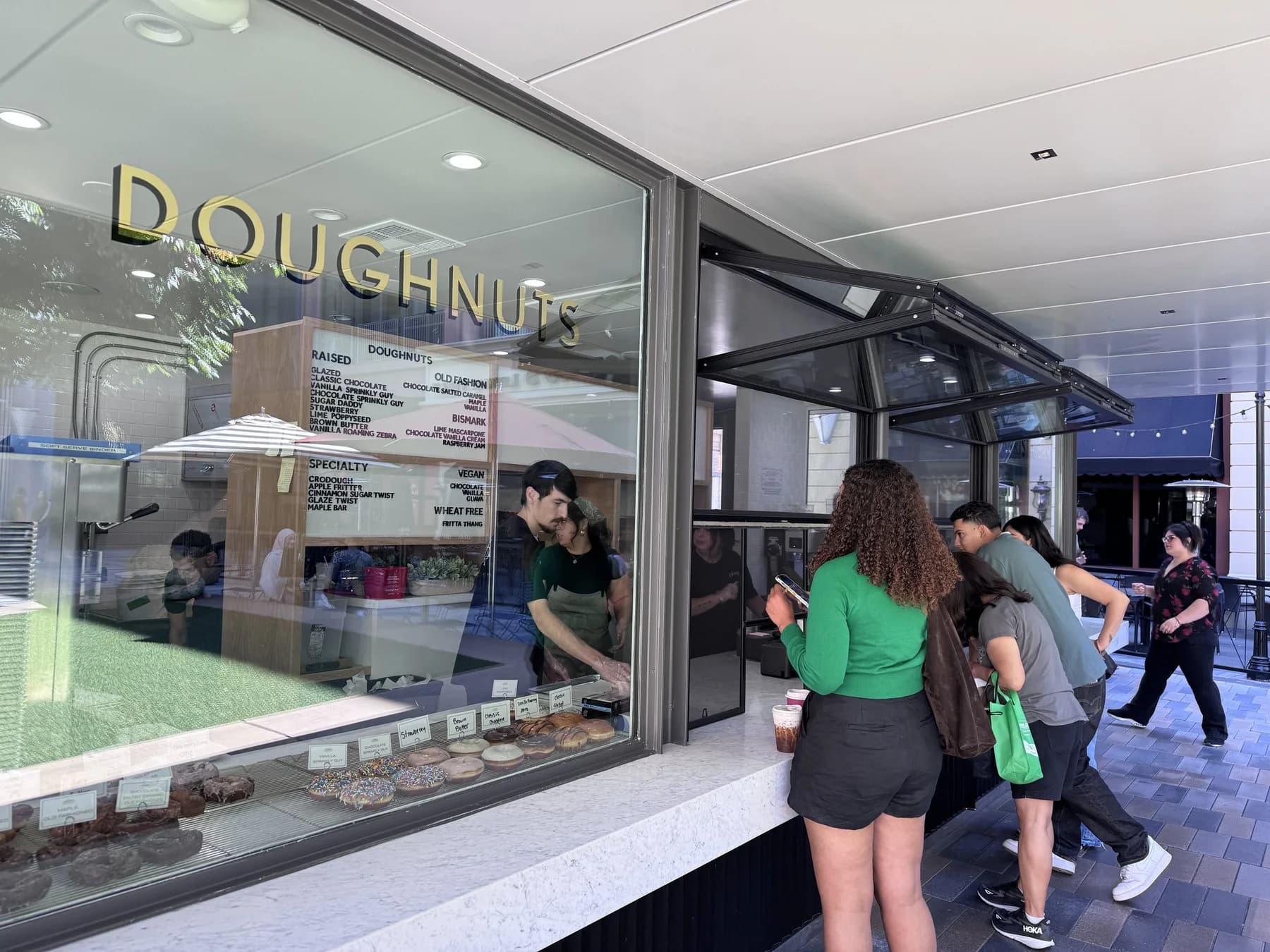 The exterior of a Johnny Doughnuts shop.
